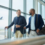 Travel for business, team at airport and men, catch flight for work trip with conference or training seminar with accountant. Walk, talk and diversity with finance convention and partnership
